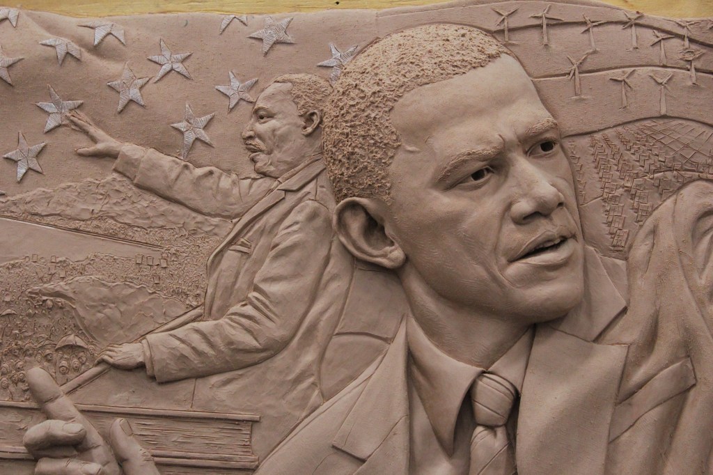 Close up of clay sculpture of Barack Obama and Martin Luther King Jr. by artist Julie Rotblatt-Amrany