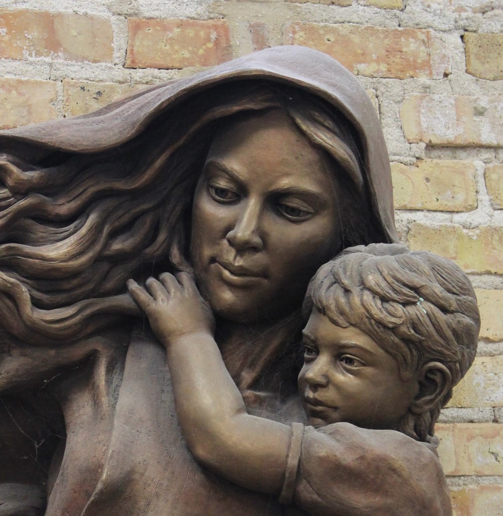 Bronze sculpture closeup of Madonna and Child by Julie Rotblatt-Amrany at Mt. Carmel High School