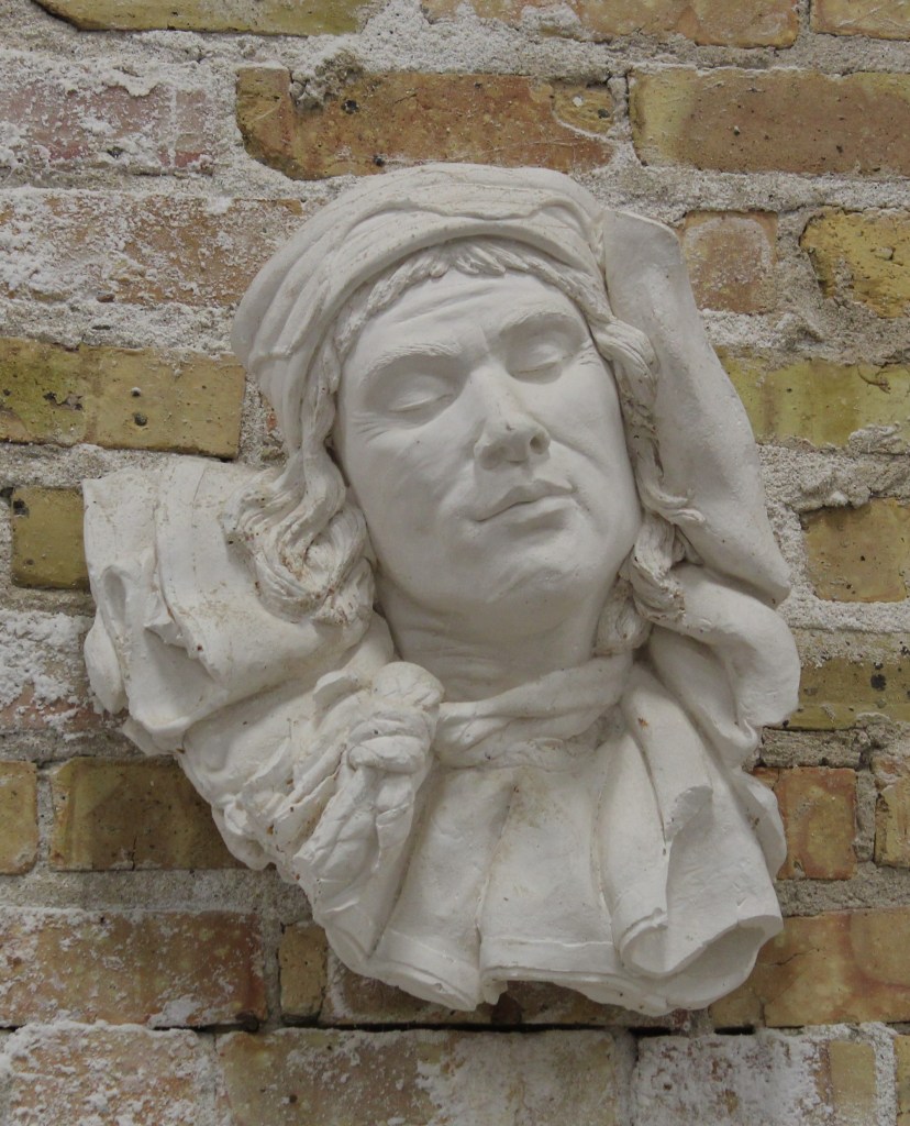 Face of Petroushka's Journey in plaster by artist Julie Rotblatt-Amrany