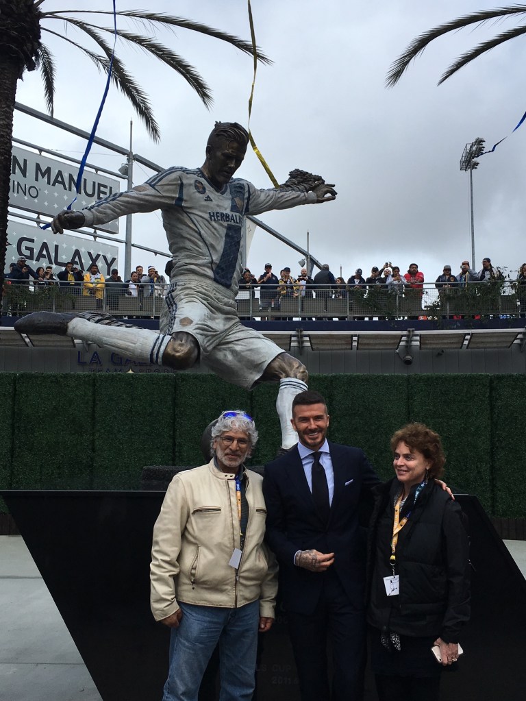 David Beckham, Julie Rotblatt-Amrany, and Omri Amrany with their bronze sculpture of David Beckham